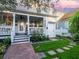 Charming home exterior with a cozy front porch and beautifully landscaped yard at 206 White Gables Dr, Summerville, SC 29483