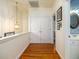 Bright hallway featuring hardwood floors, a closet with double doors, and access to a bathroom at 206 White Gables Dr, Summerville, SC 29483
