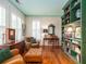 Cozy living room boasts hardwood floors, a teal ceiling, and built-in shelving showcasing collectibles at 206 White Gables Dr, Summerville, SC 29483