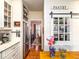 Pantry with stainless steel refrigerator and sliding barn door with glass windows at 206 White Gables Dr, Summerville, SC 29483