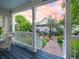 Charming front porch overlooking a beautiful garden with stone pathway and pergola at 206 White Gables Dr, Summerville, SC 29483