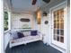 Inviting covered porch with a comfortable swing and ceiling fan at 206 White Gables Dr, Summerville, SC 29483