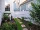 Side yard garden with stone pathway, white fence, and flowering bushes at 206 White Gables Dr, Summerville, SC 29483