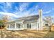 Back exterior featuring light gray siding, a sunroom, a chimney, and a fenced yard at 207 Thomaston Ave, Summerville, SC 29485