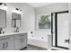 Modern bathroom with dual sinks, a soaking tub, and a separate shower at 207 Thomaston Ave, Summerville, SC 29485