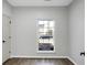 Bedroom with sleek floors, gray walls, white baseboards, and a bright window at 207 Thomaston Ave, Summerville, SC 29485
