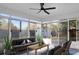Bright sunroom with ceiling fan, large windows with backyard view, cozy furniture at 207 Thomaston Ave, Summerville, SC 29485