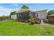 Exterior view of home with backyard screened porch, landscaping, and above ground pool at 215 Hines Dr, Bonneau, SC 29431