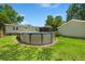 Backyard view showcasing the above ground pool and ample green space at 215 Hines Dr, Bonneau, SC 29431