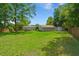 Expansive backyard with above-ground pool, detached garages, and fenced perimeter at 215 Hines Dr, Bonneau, SC 29431