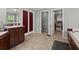 Spacious bathroom with tile floors, double doors, single vanity, and abundant storage at 215 Hines Dr, Bonneau, SC 29431