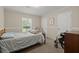Neutral bedroom with a comfortable bed, wheelchair, and views of the backyard through the window at 215 Hines Dr, Bonneau, SC 29431