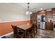 Dining area off kitchen featuring matching cabinets, stainless fridge, and a wooden table set for four at 215 Hines Dr, Bonneau, SC 29431