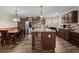 Kitchen with dining area featuring dark wood cabinets and appliances, wood flooring and plenty of natural light at 215 Hines Dr, Bonneau, SC 29431
