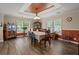 Elegant dining room with a tray ceiling, ample natural light, and stylish decor at 215 Hines Dr, Bonneau, SC 29431