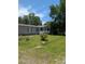 Inviting one-story home featuring a cozy front porch, green lawn, and mature trees at 215 Hines Dr, Bonneau, SC 29431