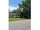Well-maintained one-story home with a welcoming front porch, situated on a green lawn with mature trees at 215 Hines Dr, Bonneau, SC 29431