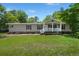 Inviting single-story house with a lovely front porch and lush green lawn at 215 Hines Dr, Bonneau, SC 29431