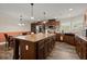 Well-equipped kitchen features an expansive center island, wooden cabinetry, and modern stainless steel appliances at 215 Hines Dr, Bonneau, SC 29431