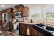 This kitchen features modern stainless steel appliances, a farmhouse style sink, and light-filled windows at 215 Hines Dr, Bonneau, SC 29431