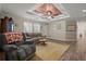 Bright living room featuring cozy seating, wood-look flooring, and a tray ceiling detail at 215 Hines Dr, Bonneau, SC 29431