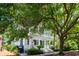 Stately two-story home with a charming front porch and balcony shaded by mature trees at 220 Ponsbury Rd, Mount Pleasant, SC 29464