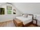 Bright attic bedroom with wood floors, a trunk, and unique wall decor at 220 Ponsbury Rd, Mount Pleasant, SC 29464