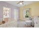 Bedroom featuring a crib, glider, and soft pastel colors at 220 Ponsbury Rd, Mount Pleasant, SC 29464