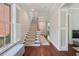 Bright and airy entryway with hardwood floors, staircase, and natural light from a large window at 220 Ponsbury Rd, Mount Pleasant, SC 29464