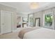 Spacious main bedroom with chandelier, large windows, mirror, and sitting area at 220 Ponsbury Rd, Mount Pleasant, SC 29464