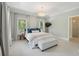 Bedroom with large windows, chandelier, and a decorative bench at the foot of the bed at 220 Ponsbury Rd, Mount Pleasant, SC 29464