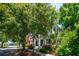 Inviting two-story home with a covered porch, set back from the street with lush landscaping at 220 Ponsbury Rd, Mount Pleasant, SC 29464