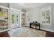 Bright office with bookshelves, shutters, piano, and an area rug with a turtle design at 220 Ponsbury Rd, Mount Pleasant, SC 29464