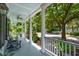 Relaxing front porch with rocking chairs and a view of the picturesque, tree-lined neighborhood at 220 Ponsbury Rd, Mount Pleasant, SC 29464