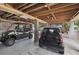A covered parking area featuring two cars and an open beam ceiling at 2218 Myrtle Ave, Sullivans Island, SC 29482