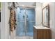 Tiled bathroom featuring a shower, vanity, and mirror at 2218 Myrtle Ave, Sullivans Island, SC 29482