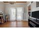 A room with wood floors, French doors, and a beaded chandelier, perfect for relaxation at 2218 Myrtle Ave, Sullivans Island, SC 29482