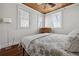 Bright bedroom with two windows, wood floors, and a simple bed at 2218 Myrtle Ave, Sullivans Island, SC 29482
