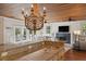 Open kitchen featuring granite countertops, stainless steel appliances, and a wooden-beaded chandelier at 2218 Myrtle Ave, Sullivans Island, SC 29482
