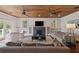 Cozy living room featuring a fireplace, comfortable seating, wood ceiling, and stylish decor at 2218 Myrtle Ave, Sullivans Island, SC 29482