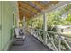 Charming porch offers a serene outdoor space with cozy seating and view at 2218 Myrtle Ave, Sullivans Island, SC 29482