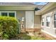 The backyard exterior features a service entry door and utilities access with mature landscaping at 2438 Hansard Dr, North Charleston, SC 29406