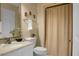 Compact bathroom featuring a vanity, toilet, and shower with a neutral shower curtain at 2438 Hansard Dr, North Charleston, SC 29406