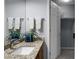Bathroom showcasing granite countertop vanity and tiled floors, complemented by modern fixtures at 2438 Hansard Dr, North Charleston, SC 29406