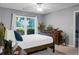 Serene bedroom with natural light, ceiling fan, soft gray walls, and decorative plants at 2438 Hansard Dr, North Charleston, SC 29406