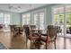 Bright dining area featuring multiple tables and chairs with large windows, creating a comfortable setting at 2438 Hansard Dr, North Charleston, SC 29406