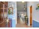 Inviting foyer with wood floors, beautiful accent wall, and view into a spacious living area at 2438 Hansard Dr, North Charleston, SC 29406