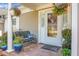 Charming front porch with brick flooring, potted plants, and a cozy bench for relaxation at 2438 Hansard Dr, North Charleston, SC 29406