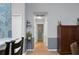 Well-lit hallway with neutral decor, leading to various rooms with wood floors and a cabinet at 2438 Hansard Dr, North Charleston, SC 29406