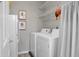 Functional laundry room featuring a washer, dryer, and storage shelves for convenience at 2438 Hansard Dr, North Charleston, SC 29406